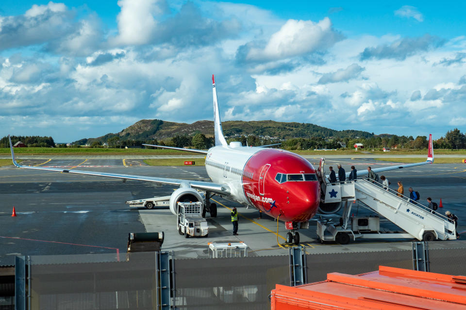 Norwegian Air Shuttle Boeing 737-800 aircraft with registration LN-DYE as seen with passengers boarding on the airplane for departure at Ålesund Airport, Vigra AES ENAL in Møre og Romsdal county, Norway. Norwegian Air Shuttle DY NAX NOR is a low-cost budget airline, the third largest carrier in Europe, famous for the red nose livery and the portraits of high achievers on the tail fins of the aircraft. The airline the past days faced financial issues, struggling to pay the dept and their bondholders and shareholders, seeking now for financial survival, with the problem being intensified after the grounding of 18 of their Boeing 737 MAX. The airline connects Alesund to Oslo - Gardemoen and Alicante seasonal. (Photo by Nicolas Economou/NurPhoto via Getty Images)