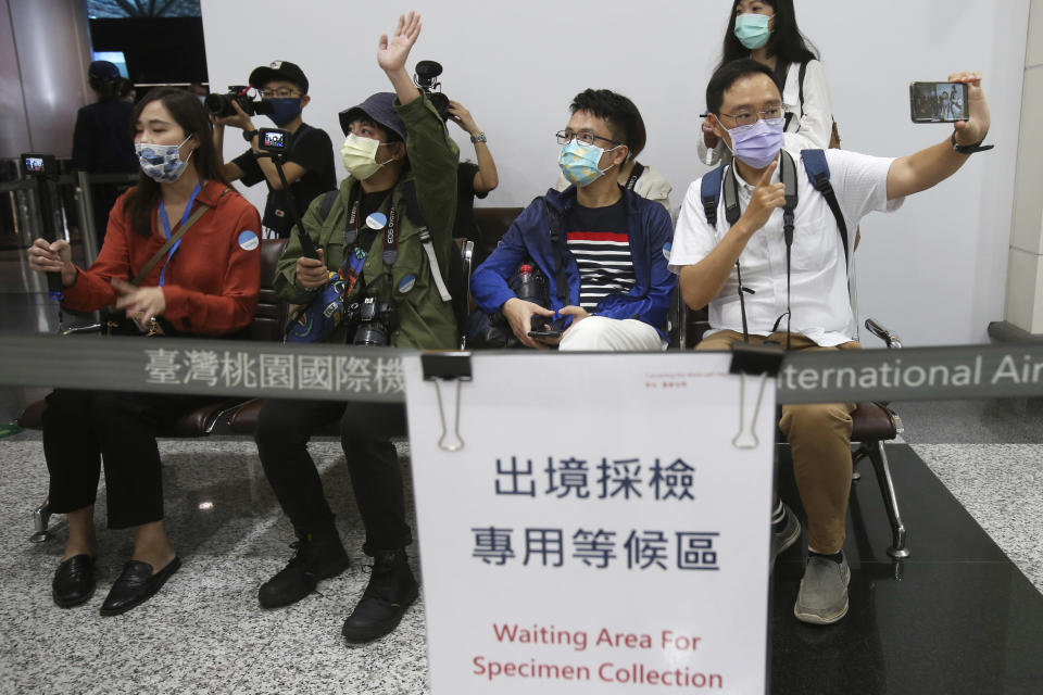 Taiwanese travelers from the first group of Palau-Taiwan Travel Corridor prepare to take COVID-19 virus antigen test before leaving Taiwan, at Taoyuan International Airport in Taoyuan, northern Taiwan, Thursday, April 1, 2021. The Palau-Taiwan Travel Corridor, allowing people to travel between the islands without a COVID-19 quarantine, has started Thursday. (AP Photo/Chiang Ying-ying)