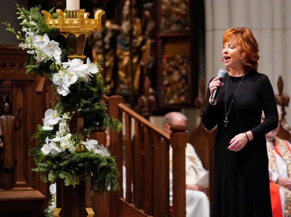 39) Reba McEntire sings during the service.