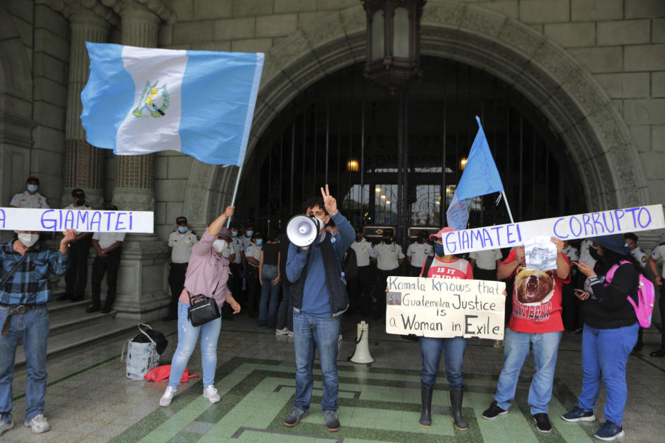 Demonstrators protest in front of the National Palace in Guatemala after a meeting between Vice President Kamala Harris and Guatemalan President Alejandro Giammattei, in Guatemala City, Monday, June 7, 2021. (AP Photo/Oliver de Ros)