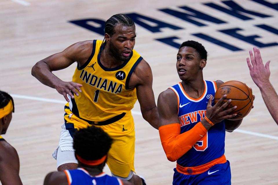 New York Knicks guard RJ Barrett (9) drives on Indiana Pacers forward T.J. Warren (1) during the second half of an NBA basketball game in Indianapolis, Wednesday, Dec. 23, 2020. (AP Photo/Michael Conroy).