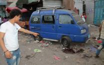 A Yemeni man points at a pool of blood at the site of rocket fire by Huthi Shiite rebels and their allies in Aden's loyalist-held al-Mansura district Aden on July 1, 2015. Rebel fire on a residential district of Yemen's second city Aden killed at least 20 civilians as loyalist forces in central city Taez launched a manhunt for 1,200 escaped prisoners. AFP PHOTO / SALEH AL-OBEIDI