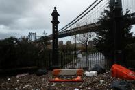 NEW YORK, NY - OCTOBER 30: Debris litters a flooded street in the Dumbo section of Brooklyn after the city awakens to the affects of Hurricane Sandy on October 30, 2012 in New York, United States. At least 15 people were reported killed in the United States by Sandy as millions of people in the eastern United States have awoken to widespread power outages, flooded homes and downed trees. New York City was his especially hard with wide spread power outages and significant flooding in parts of the city. (Photo by Spencer Platt/Getty Images)