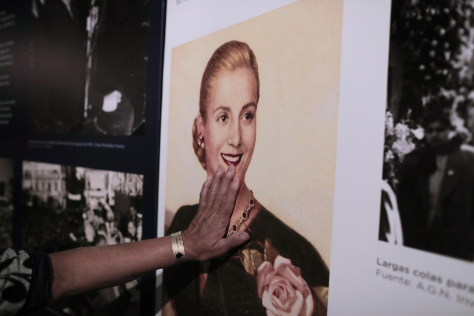 A woman touches a picture of Eva Peron on display at the home-turned-museum "Casa Museo Eva Perón" in Los Toldos, Argentina, Monday, May 6, 2019. One day ahead of the 100th anniversary of Evita's birth, the home where Argentina's mythical first lady was born and raised was opened to the public with an exhibition recounting the childhood of the woman who, together with her husband Juan Domingo Perón, will forever mark Argentine history. (AP Photo/Natacha Pisarenko)