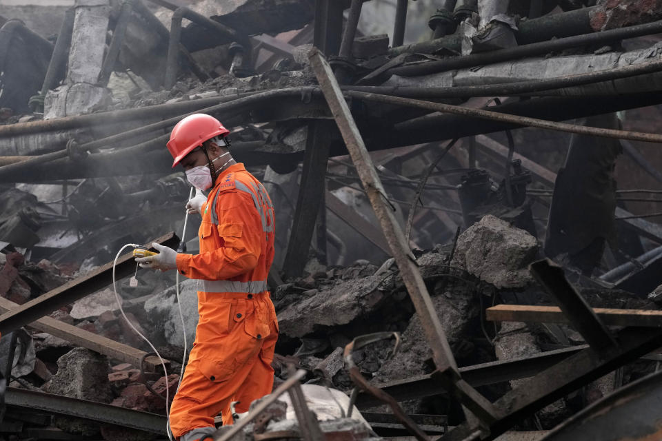 A National Disaster Response Force rescuer works at the site after an explosion and fire at a chemical factory in Dombivali near Mumbai, India, Friday, May 24, 2024. Multiple people were killed and dozens were injured in the incident that happened Thursday. (AP Photo/Rajanish Kakade)