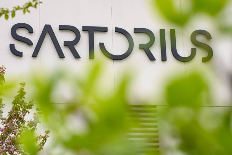 The Sartorius AG logo can be seen on one of the company's buildings. German medical lab equipment maker Sartorius AG has reported lower earnings and revenue for the full fiscal year 2023 compared to 2022. Swen Pförtner/dpa