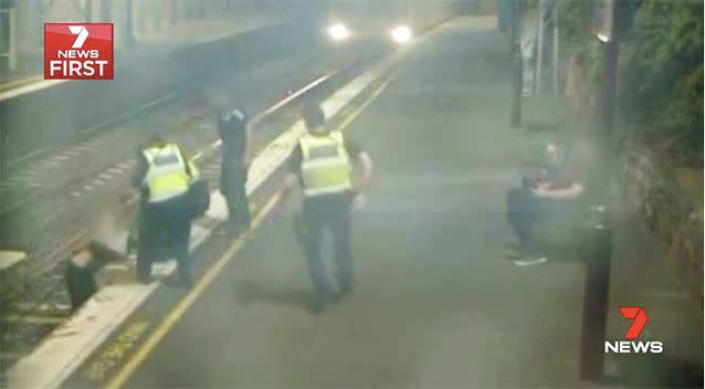 Two other PSOs notice the woman in danger and come to help her as a train approaches. Picture: 7 News