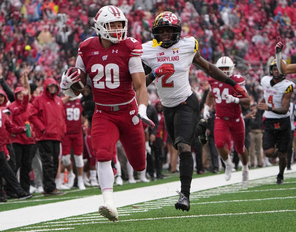 Wisconsin running back Isaac Guerendo outruns Maryland defensive back Jakorian Bennett to score an 89-yard touchdown in 2022.