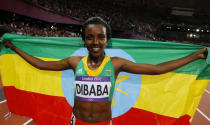 Ethiopia's Tirunesh Dibaba celebrates with her national flag after she won the women's 10,000m final at the London 2012 Olympic Games at the Olympic Stadium August 3, 2012. REUTERS/Phil Noble (BRITAIN - Tags: SPORT ATHLETICS OLYMPICS) 