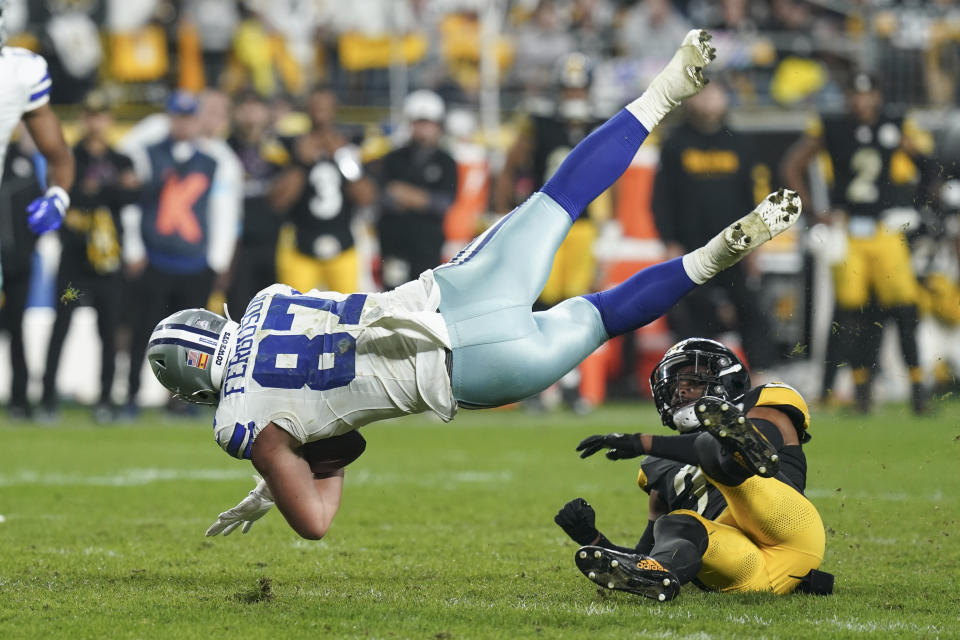 Dallas Cowboys tight end Jake Ferguson (87) is tripped by Pittsburgh Steelers safety Minkah Fitzpatrick during the second half of an NFL football game, Sunday, Oct. 6, 2024, in Pittsburgh. (AP Photo/Matt Freed)