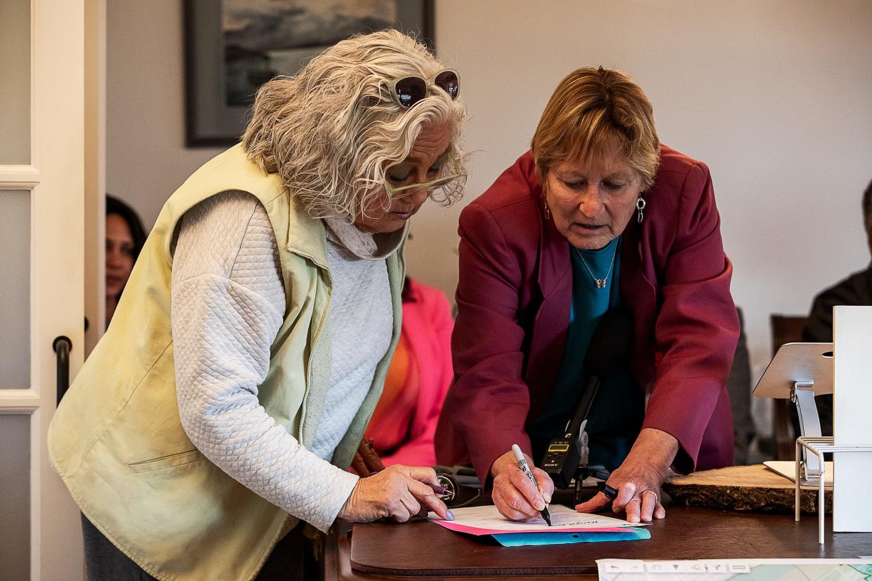 State Rep. and Louisville Democrat Mary Lou Marzian, right, signed a Notice of Candidate Withdrawal during a press conference on Monday, March 28, 2022. To her right is attorney and notary Mikki Adams. Marzian is bowing out after being forced into a primary battle against her colleague, Rep. Josie Raymond, when Republican lawmakers approved new redistricting plans this year that put both women in the same district. 