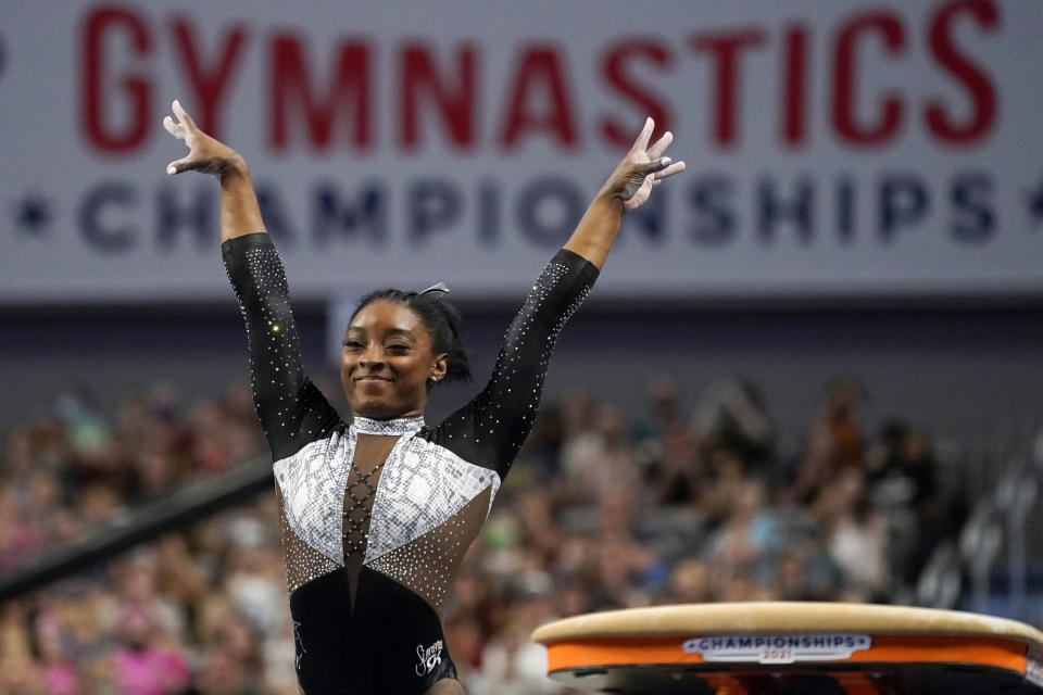 Simone Biles celebrates after competing in the vault during the U.S. Gymnastics Championships, Sunday, June 6, 2021, in Fort Worth, Texas. (AP Photo/Tony Gutierrez)