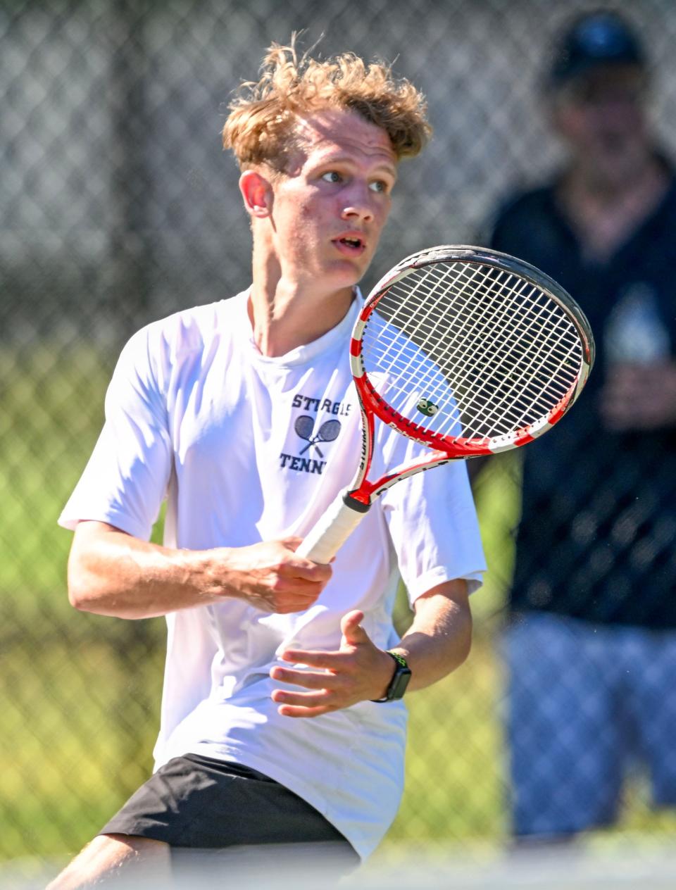 Sturgis number two singles player Ben Bass follows through on shot at his Cohasset opponent in the Division 4 Round of 16 tennis playoffs.