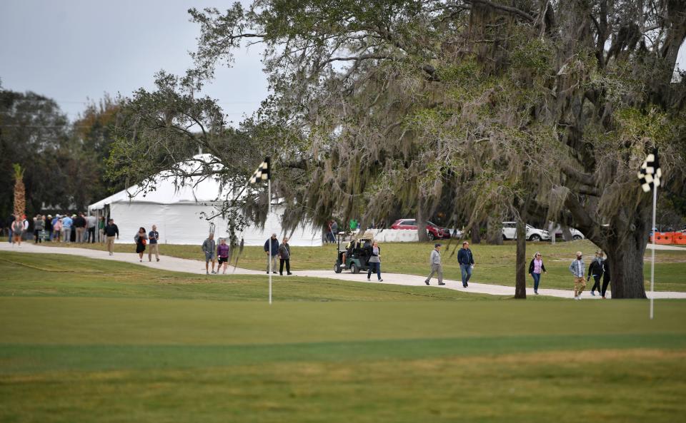 Guests at the grand re-opening ceremony for the Bobby Jones Golf Club and Nature Park walk along a path toward the new Nature Park at Bobby Jones. .