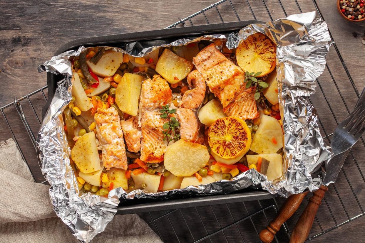 Foil pack dinners. Salmon with vegetables baked in foil. Dietary food. Top view