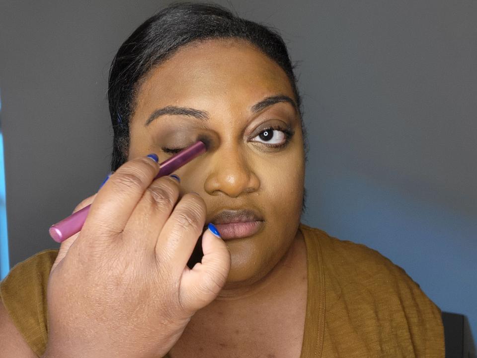 The writer adds a brown eyeshadow shade to her crease