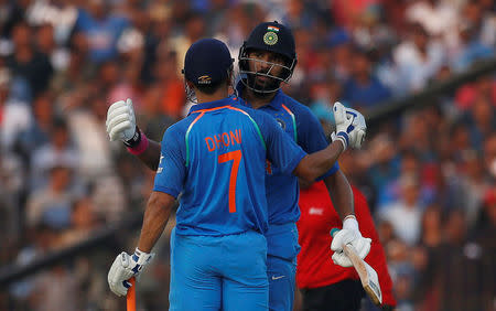 Cricket - India v England - Second One Day International - Barabati Stadium, Cuttack, India - 19/01/17. India's Yuvraj Singh congratulates his teammate Mahendra Singh Dhoni for his century. REUTERS/Adnan Abidi