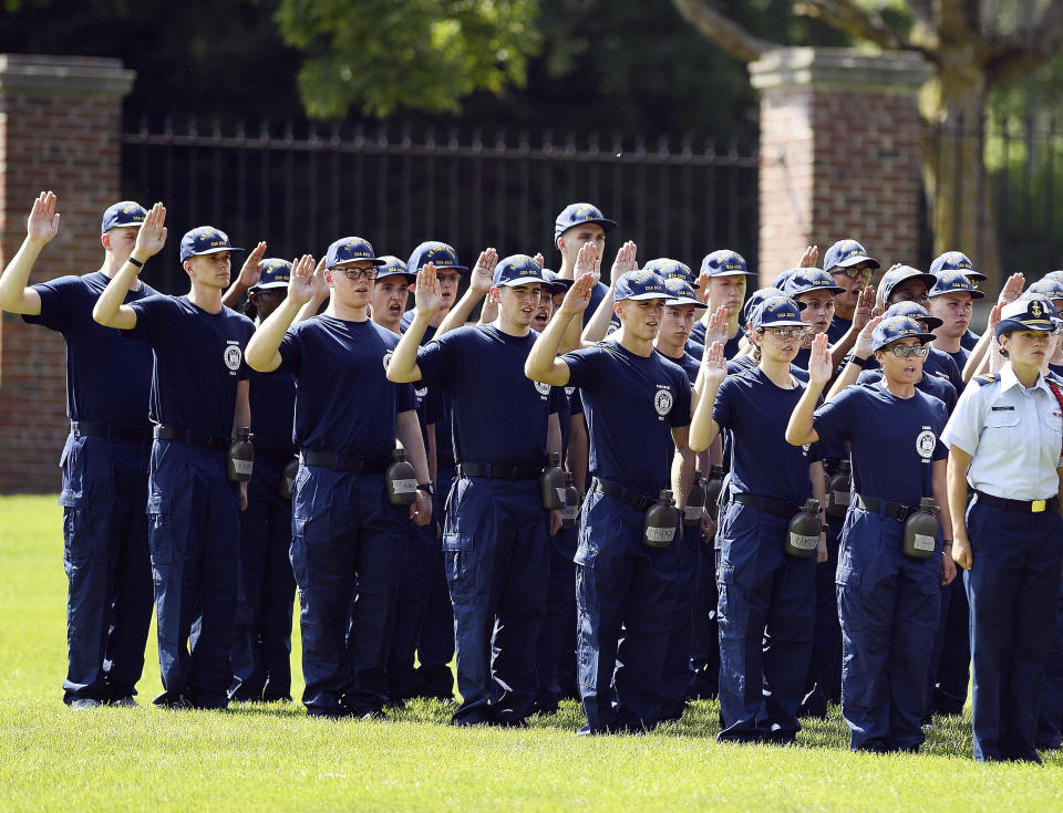 FILE — In this July 1, 2019 file photo, members of the U.S. Coast Guard Academy Class of 2023 take their oath of office on the first day of Swab Summer in New London, Conn. The school, like other service academies and military training centers, has made major changes because of the coronavirus pandemic. That means the eight weeks of boot camp for new cadets, known as "Swab Summer," will be much different. There will be no haircuts, no drilling, no running as a group from place to place, no lining up against the wall in the hall of the barracks for pushups. (Sean D. Elliot//The Day via AP, File)