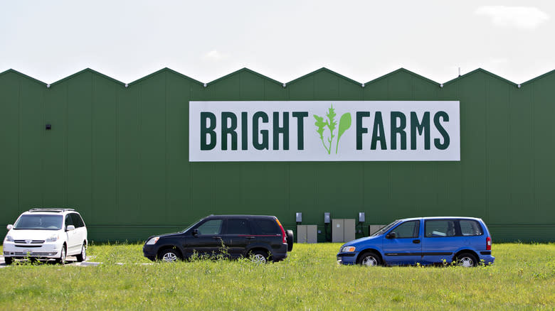 The exterior of the BrightFarms building with cars