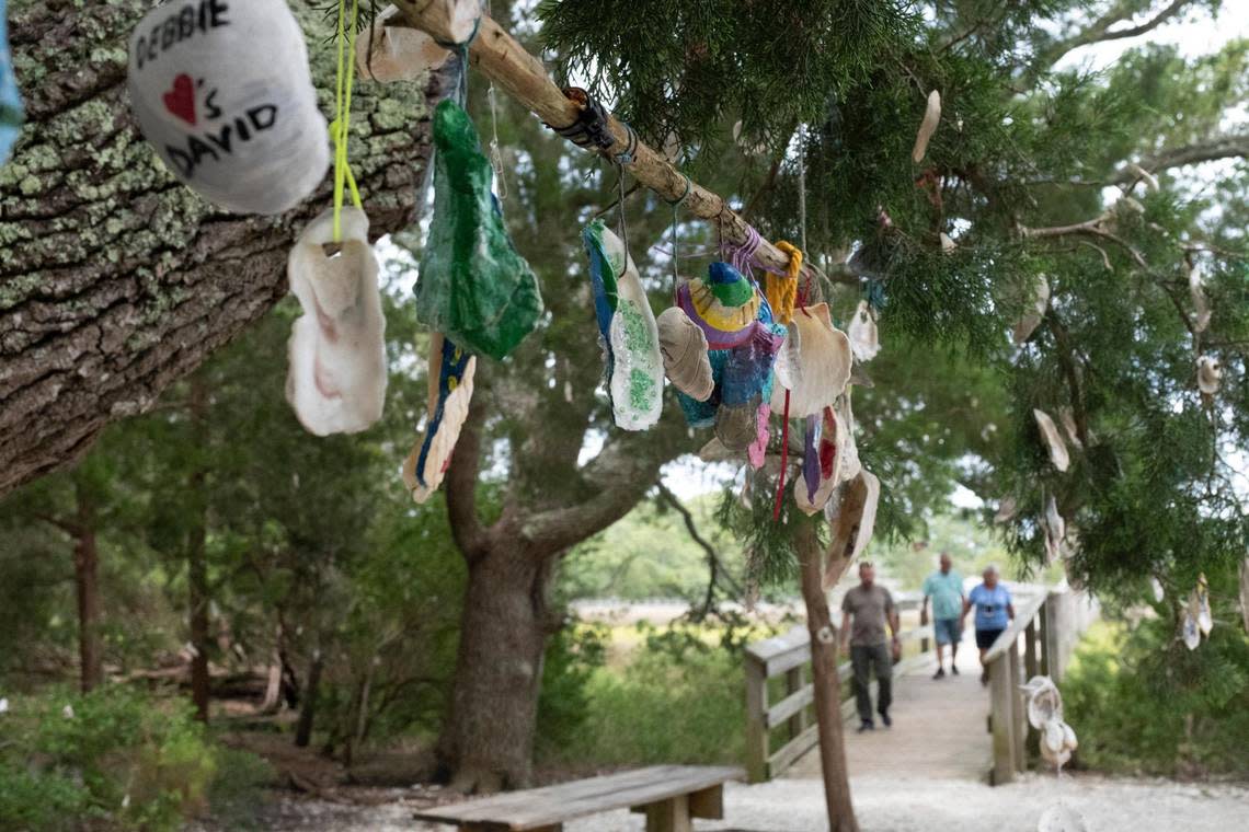 Visitors walk on boardwalks over the marsh and shells hang from trees at Vereen Memorial Gardens.