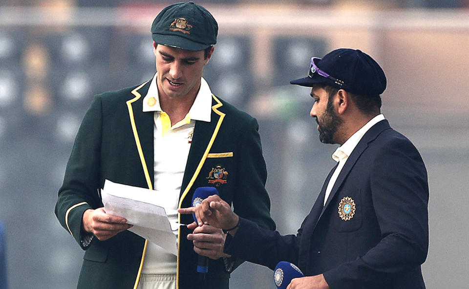 Pat Cummins, pictured here speaking with Rohit Sharma before the second Test in India.