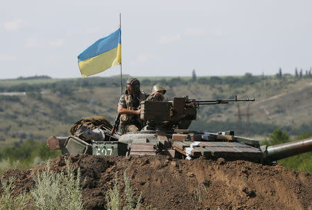 Ukrainian soldiers look out from a tank at a position some 60 km from the eastern Ukrainian city of Donetsk, July 10, 2014. REUTERS/Gleb Garanich