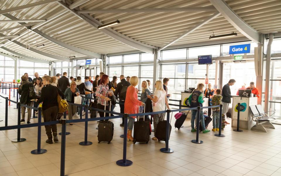 Passengers wait at the gate