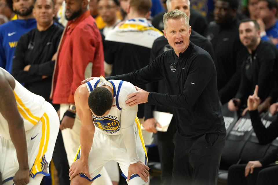 Steph Curry is consoled by coach Steve Kerr after calling an illegal time out during the fourth quarter.