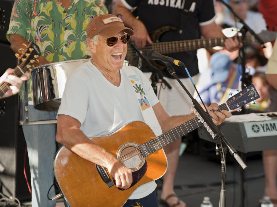 FILE - In this Friday, Nov. 4, 2011, photo provided by the Florida Keys News Bureau, singer/songwriter Jimmy Buffett performs before his fans on Duval Street in Key West, Fla. Buffett, who popularized beach bum soft rock with the escapist Caribbean-flavored song “Margaritaville” and turned that celebration of loafing into an empire of restaurants, resorts and frozen concoctions, has died, Friday, Sept. 1, 2023. (Rob O'Neal/Florida Keys News Bureau via AP)