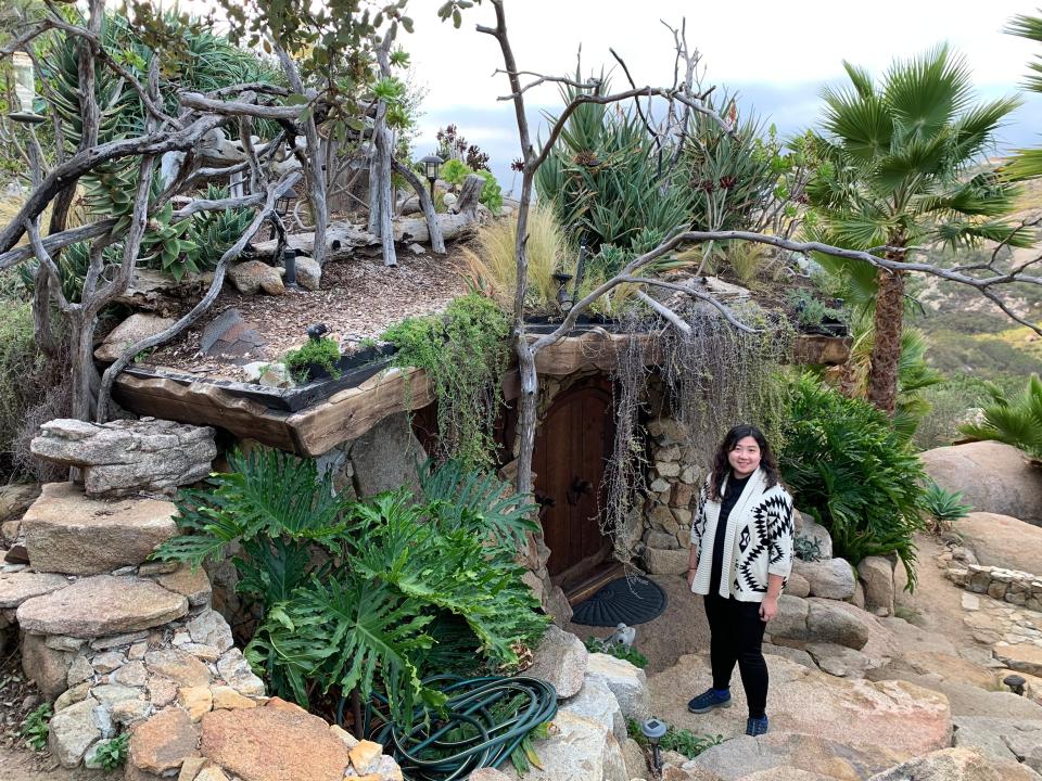 Fiona Chandra in front of the Hobbit House and living roof, "I paid $412 to Stay in a Hobbit House."