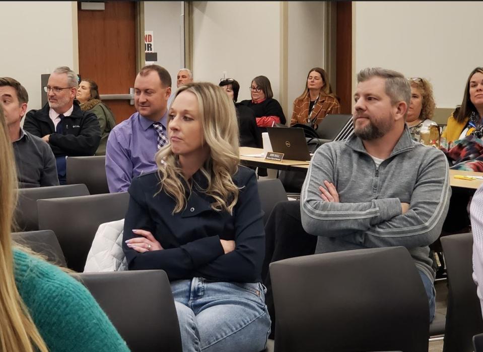 Parents Amy and Jeremy Yates listen to others defend the book "Endlessly Ever After" at the Boone County Board of Education meeting Thursday night.