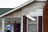 Jean Fogus, left, and her daughter Pamela Luna stand on there porch after tornado touched down damaging the siding, uprooted a tree and knocked out power to there home along Batson Drive Wednesday, Jan. 30, 2013, in Ashland City, Tenn. (AP Photo/Mark Zaleski)