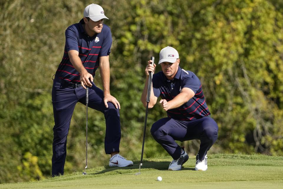 Team USA's Bryson DeChambeau and Team USA's Scottie Scheffler look over a shot on the ninth hole during a four-ball match the Ryder Cup at the Whistling Straits Golf Course Friday, Sept. 24, 2021, in Sheboygan, Wis. (AP Photo/Jeff Roberson)