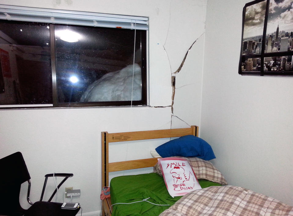 This Feb. 8, 2014 image provided by Reed College shows damage caused by a large snowball that crashed into a Grove Quad dormitory at Reed College in Portlend, Ore. The crash ripped a wall off its studs and narrowly missed a window. No one was injured in the collision. College officials say the ball was some 40 inches in diameter and weighed from 800 to 900 pounds.(AP Photo/Reed College)