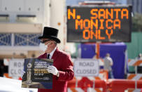 Gregg Donovan demonstrates with a sign protesting the lack of Black members in the Hollywood Foreign Press Association, outside a road closure near the 78th Golden Globe Awards at the Beverly Hilton, Sunday, Feb. 28, 2021, in Beverly Hills, Calif. (AP Photo/Chris Pizzello)