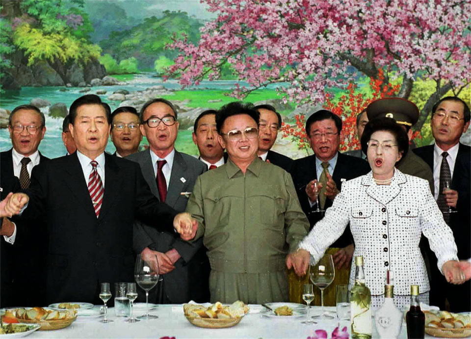 FILE - In this June 15, 2000, file photo, from left in front row; former South Korean President Kim Dae-jung, former North Korean leader Kim Jong Il, and former South Korean First Lady Lee Hee-ho, hold hands as they sing a song titled "We Are Hoping For Reunification" at the Baekhwawon Guest House in Pyongyang during a luncheon party Thursday, June 15, 2000. (AP Photo/KOREA POOL/YONHAP, File)