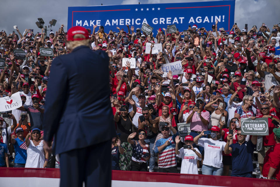 Supporters cheer as President Donald Trump arrives for a campaign rally outside Raymond James Stadium, Thursday, Oct. 29, 2020, in Tampa. (AP Photo/Evan Vucci)