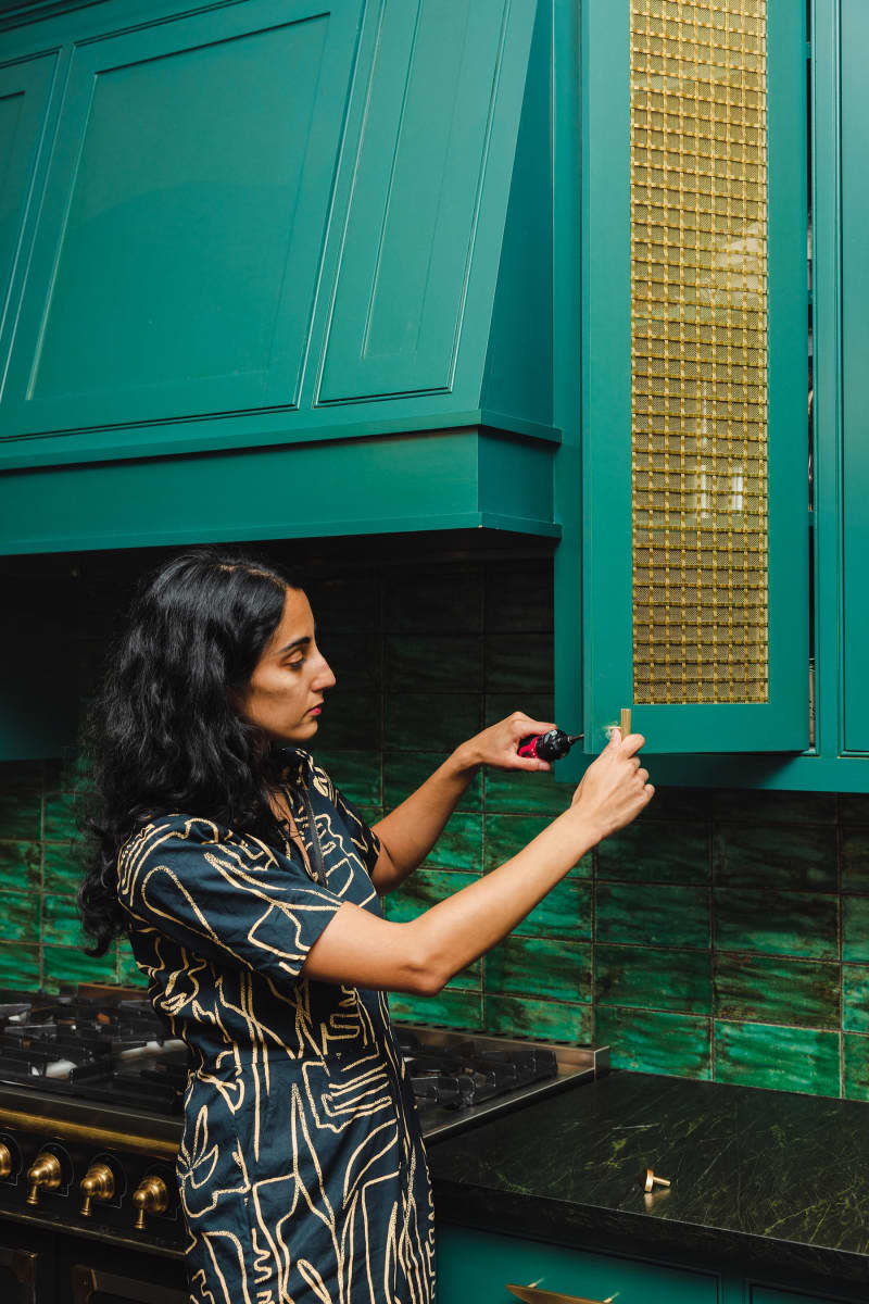 Priya the Hapny Home founder in a teal and green kitchen