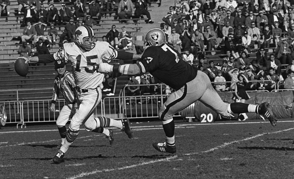 Jack Kemp avoids a sack by Oakland  defensive end Ike Lassiter in Buffalo's 1966 Thanksgiving Day victor over the Raiders.