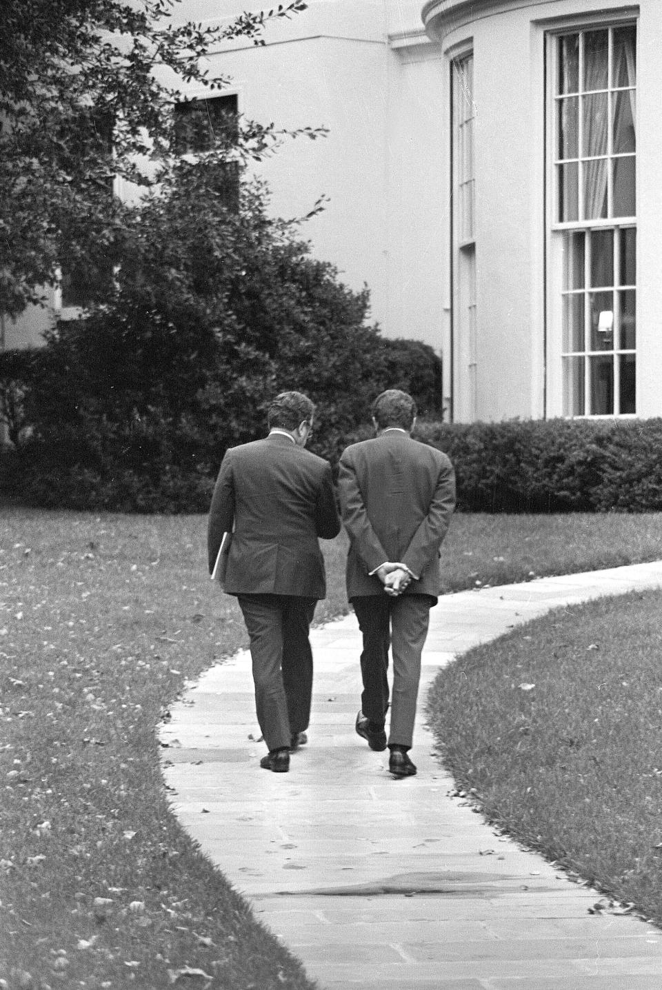 FILE - U.S. President Richard Nixon, right, and Secretary of State Henry Kissinger walk together to the White House in Washington, Oct. 31, 1973. Kissinger, the diplomat with the thick glasses and gravelly voice who dominated foreign policy as the United States extricated itself from Vietnam and broke down barriers with China, died Wednesday, Nov. 29, 2023. He was 100. (AP Photo, File)