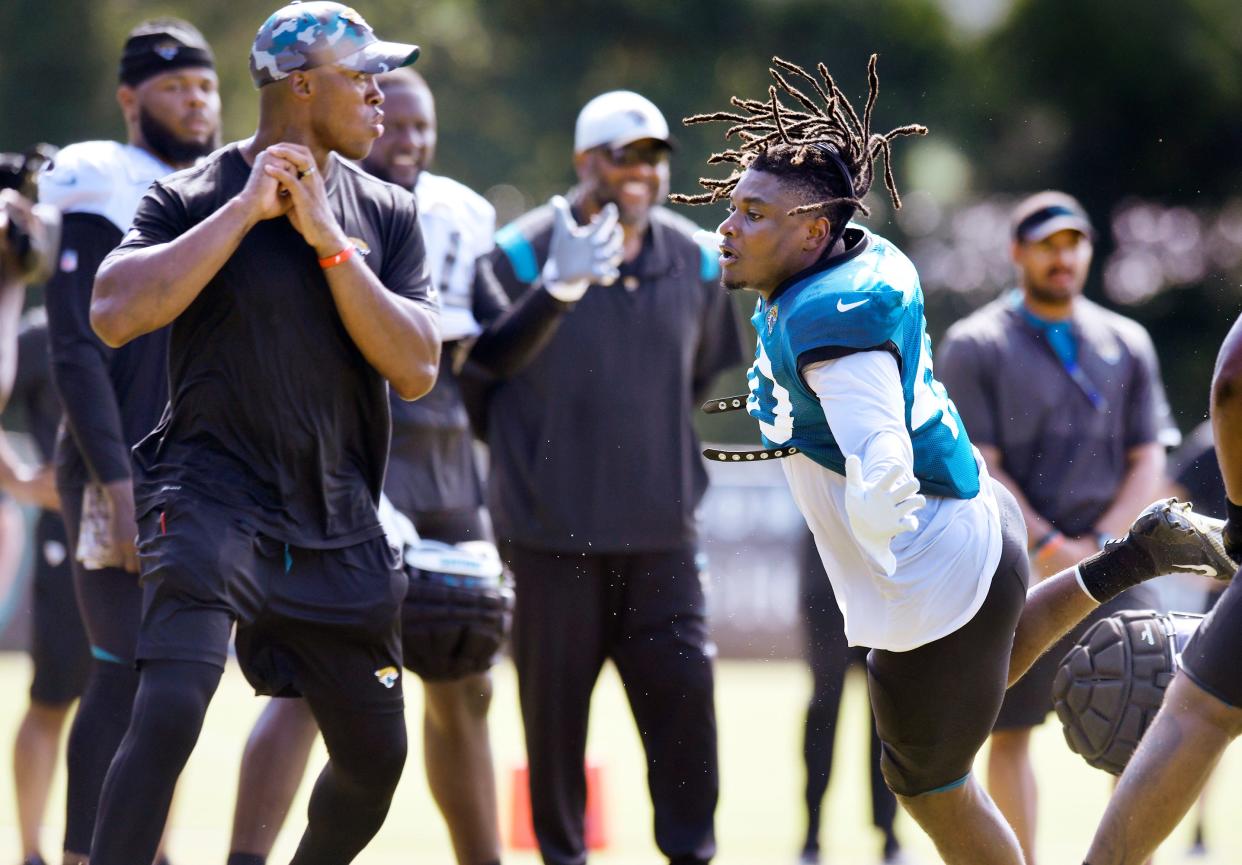 Jacksonville Jaguars defensive end/outside linebacker Jamir Jones (40) looses his helmet as he tries to get to Jaguars offensive quality control coach Henry Burris during one on one drills at Monday's training camp session. The Jacksonville Jaguars held training camp Monday, August 1, 2022, at the Episcopal School of Jacksonville Knight Campus practice fields on Atlantic Blvd.