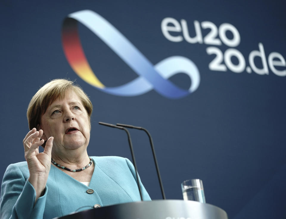 Germany's Chancellor Angela Merkel speaks to the press during a joint press conference with EU Commission President Ursula von der Leyen via videolink, in the foyer of the Federal Chancellery, in Berlin, Thursday, July 2, 2020. Merkel joined the President of the EU Commission, the three executive Vice-Presidents, the Commissioner for External Relations and the Commissioner for Internal Affairs to discuss the work programme as Germany took over the presidency of the Council of the EU. (Kay Nietfeld/dpa via AP)