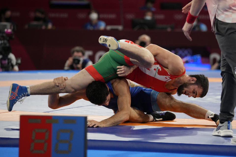 Belarus' Mahamedkhabib Kadzimahamedau, top, competes against Russian Olympic Committee's Zaurbek Sidakov during their men's freestyle 74 kg wrestling final match at the 2020 Summer Olympics, Friday, Aug. 6, 2021, in Chiba, Japan. (AP Photo/Aaron Favila)