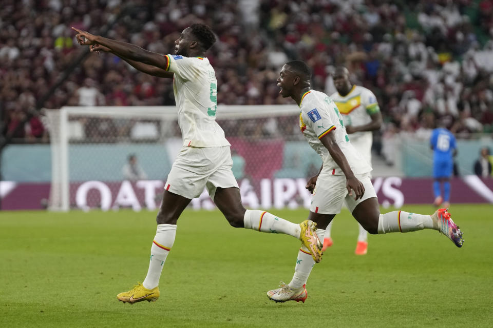 Senegal's Boulaye Dia celebrates scoring his side's first goal during the World Cup group A soccer match between Qatar and Senegal, at the Al Thumama Stadium in Doha, Qatar, Friday, Nov. 25, 2022. (AP Photo/Thanassis Stavrakis)