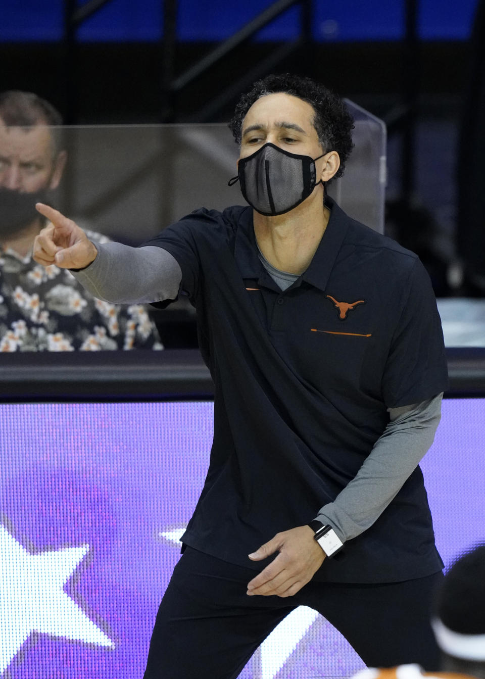 Texas head coach Shaka Smart directs his team in the first half of a semifinal NCAA college basketball game in the Maui Invitational tournament against Indiana, Tuesday, Dec.1, 2020, in Asheville, N.C. (AP Photo/Kathy Kmonicek)