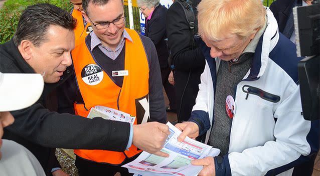 Senator Nick Xenophon assists a Labor volunteer at an SA polling station. Photo: AAP