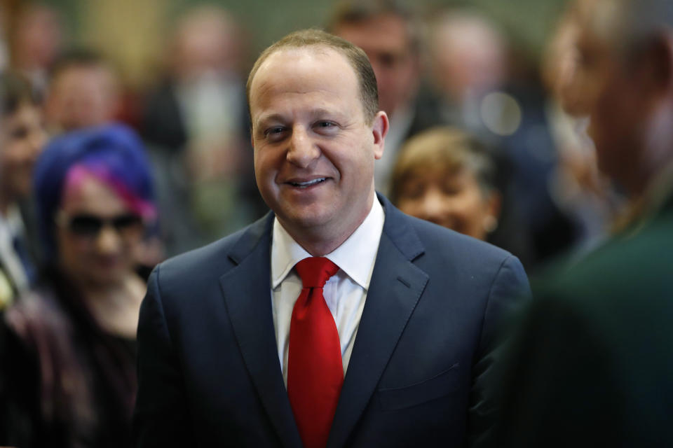 FILE - In this Jan. 10, 2019 file photo, Colorado Governor Jared Polis enters the House of Representatives chamber to make his first State of the State address to a joint session of the Colorado Legislature in Denver. A significant portion of US voters remains hesitant about supporting an LGBT candidate for president, according to a new AP-NORC poll. Yet many LGBT candidates in major non-presidential races have overcome such attitudes, and political experts predict the path for future LGBT office-seekers will steadily grow smoother. (AP Photo/David Zalubowski)