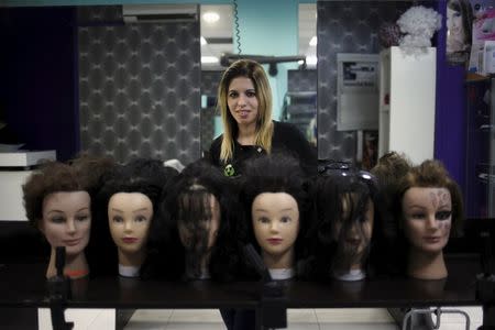 Desire Vargas, 20, poses for a photo at a hairdressing salon where she studies a course in beauty and hairdressing, in downtown Ronda, near Malaga, southern Spain, October 2, 2015. REUTERS/Jon Nazca