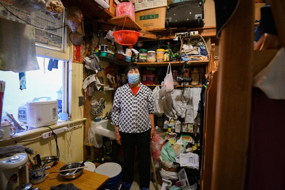 Single-room occupancy building resident Mei Chan Lao poses for a portrait of her room in San Francisco's Chinatown. Lao has lived in the same small room for eight years, and has managed to organize all of her and her husband's belongings into their 10-by-10 foot bedroom. Lao is one of the 30,000 San Franciscans living in an SRO, and because of the pandemic, it has become much harder for her to live comfortably in their space.