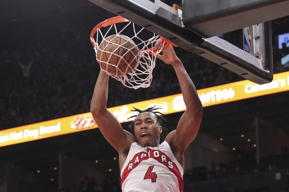 Toronto Raptors' Scottie Barnes scores against the Cleveland Cavaliers during the first half of an NBA basketball game in Toronto, Monday, Jan. 1, 2024. (Chris Young/The Canadian Press via AP)